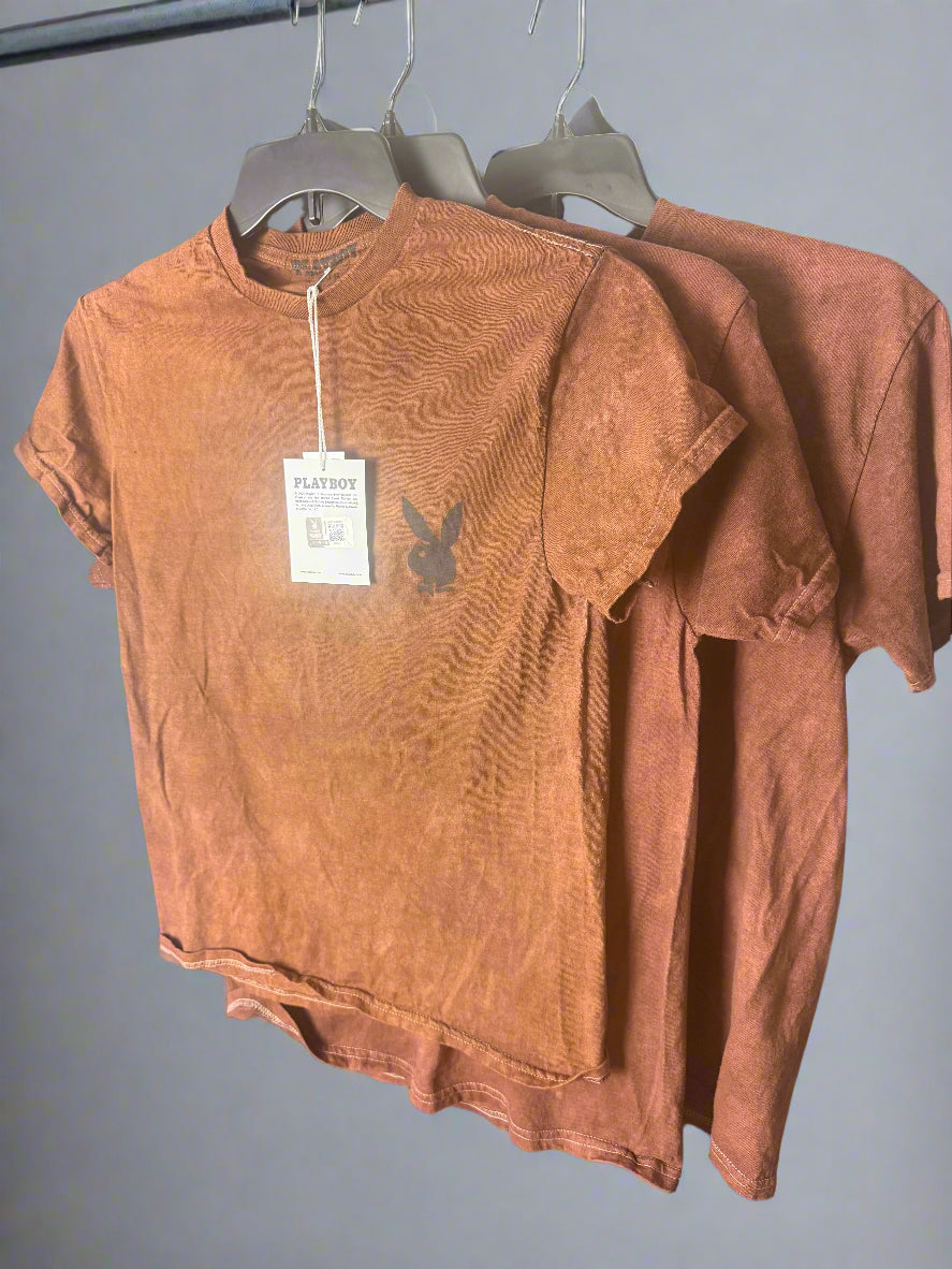 Brown shirt with a tag on a dark surface